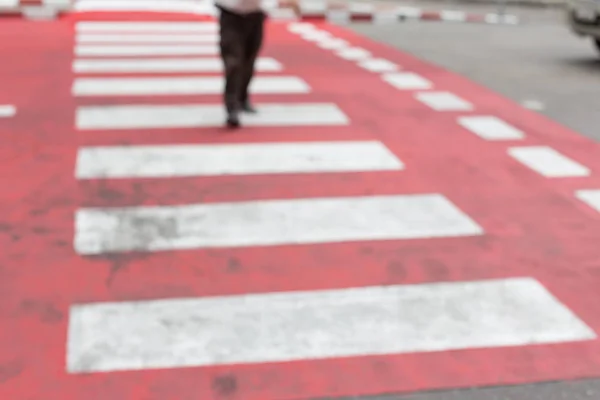 Blurred of People walking on a red crosswalk — Stock Photo, Image