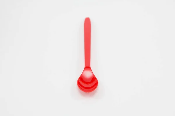Red plastic spoon — Stock Photo, Image