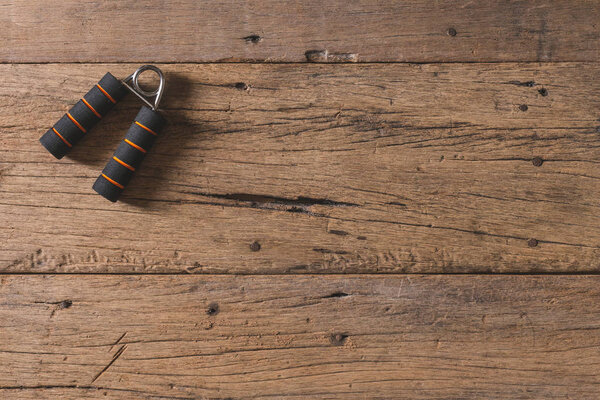 Top view Hand grip for finger exercise on the wooden table and c