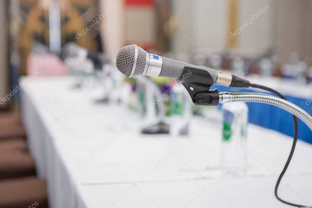 Selective focus of microphone in the seminar room on blurred background