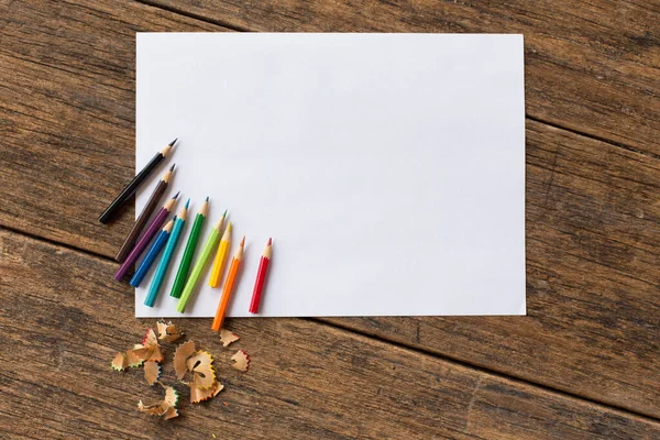 Πολύχρωμο Χρωματιστό Μολύβι Και Λευκό Χαρτί Ξύλινο Φόντο — Φωτογραφία Αρχείου