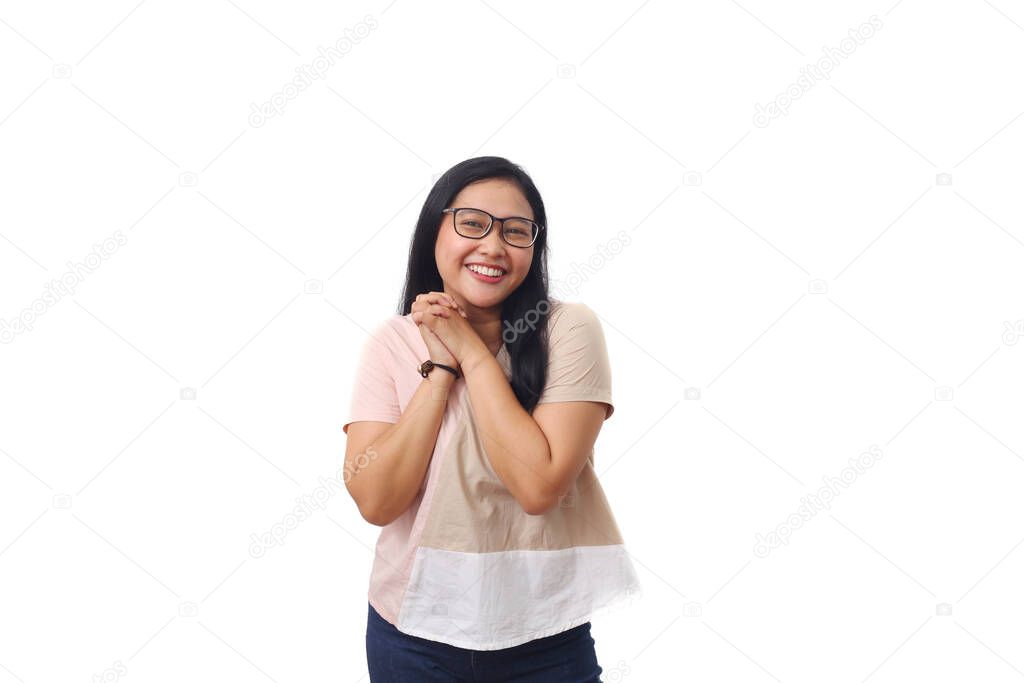Beautiful young Asian girl smiles in admiration while looking at the camera. Isolated on white background