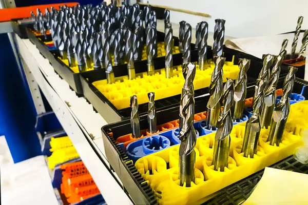 Ready twist drills made from metal base bars on yellow plastic support. Horizontal, tools and instruments