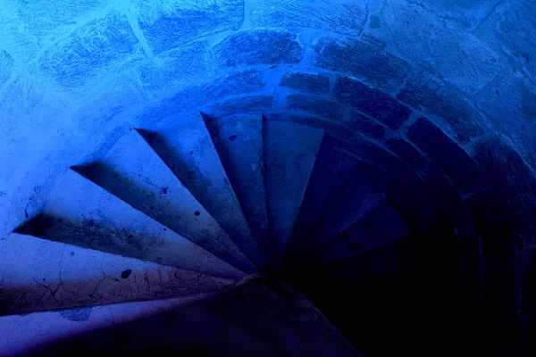 Old Spiral stairs of ancient castle made from stones, top view, horizontal, mediterranean, architecture, golden spiral. Classic, blue monochrome, trend 2020