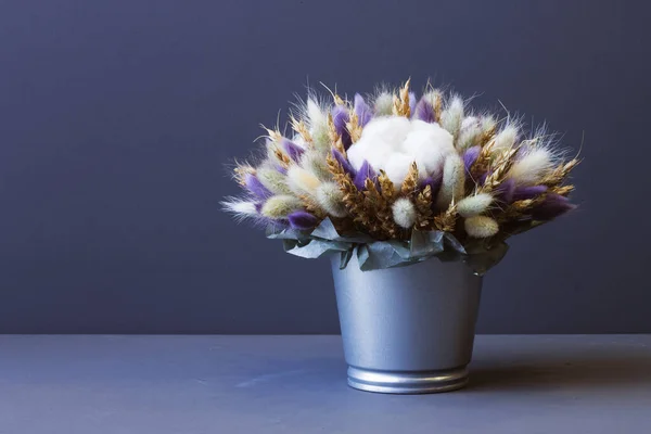 composition of dried flowers against gray background copy space