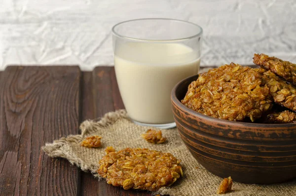 Pumpkin vegan oatmeal cookies with oat milk on wooden background