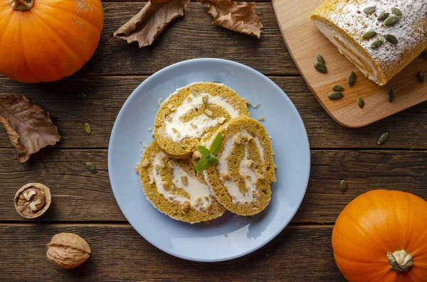 Pumpkin Roll with powdered sugar with walnuts and pumpkin seeds. Top View. — Stock Photo, Image