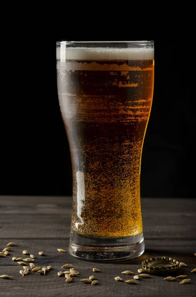 Beer bottle on black background with glass of beer — Stock Photo, Image