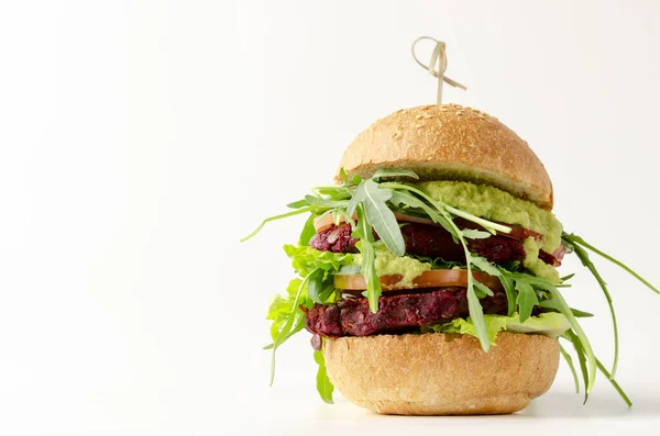 Veggie beet and lentil burgers with vegetables and avocado sauce.