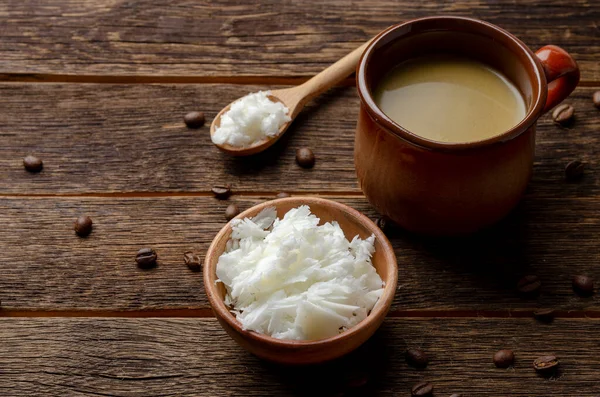 Bulletproof coffee with butter, recipe for ketogenic diet on a wooden