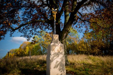 Moravya tarlaları arasında yol kenarında duran bir yol kenarı haçı.