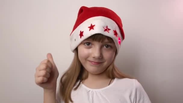 Eight Year Old Funny Caucasian Girl Santa Claus Hat Blinking — Stock Video