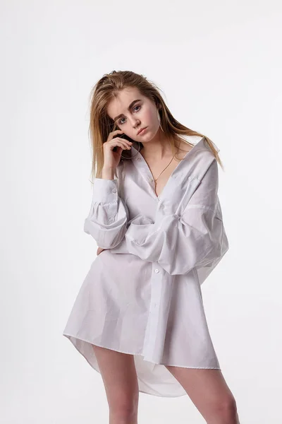 Young pretty female wearing shirt posing in studio with bare feet, model tests — 스톡 사진