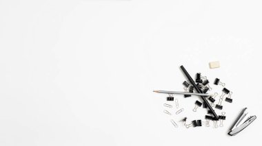 office stationery tools randomly scattered in heap on white background, flat lay