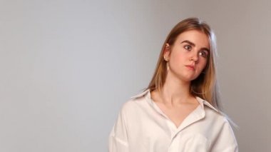 caucasian pretty female with piercing in nose removes blue glove from her hand