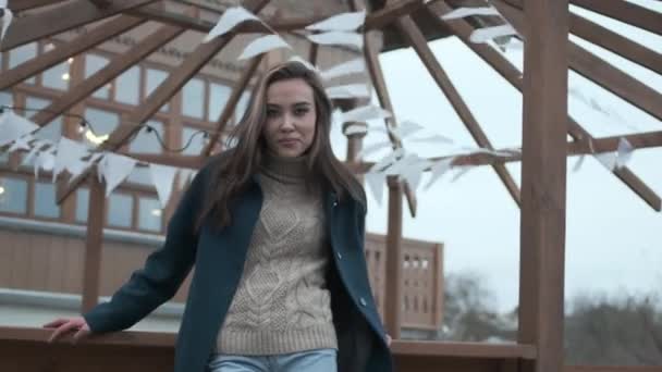 Stylish smiling asian pretty girl in blue coat and turtleneck looking at camera — 비디오