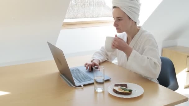 Freelance woman in white bathrobe, towel on head. stay home quarantine concept — Stock Video