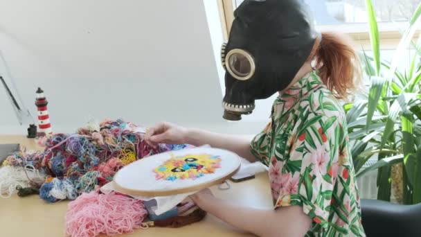 Needlework, handicraft in gas mask. Stay home, quarantine leisure funny concept — Stock Video