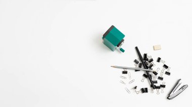 office stationery tools randomly scattered in heap on white background, flat lay