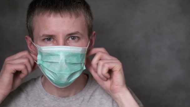 Young man takes off protective mask. virus protection, prevention of infection — Stock Video