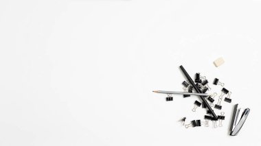 office stationery tools randomly scattered in heap on white background, flat lay