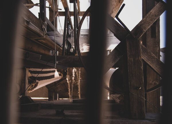 A loom is used to weave cloth and tapestry. The purpose is to hold the warp threads under tension to facilitate the interweaving of the weft threads