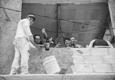 Holbox, Quintana Roo, Mexico / - Jun 2017 The Importance of Happiness in the Workplace Concept Happy Mexican Mason Workers on a construction
