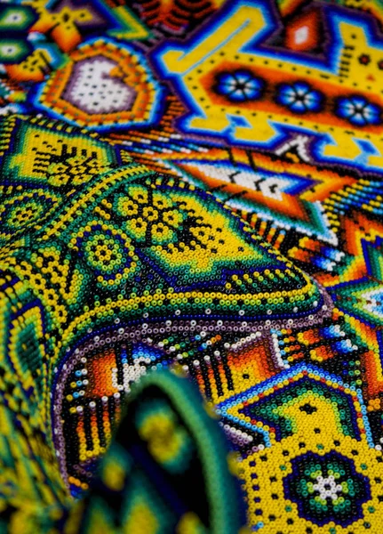 Close up of Mexican Huichol Art, Colorful decoration using symbols and designs which date back centuries, products are \