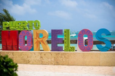 Puerto Morelos, Riviera Maya, Mexico This original coastal fishing village is now a quiet, colorful mixed-use neighborhood of private homes, few hotels, beautiful vegetation, bars, condominiums, restaurants, and nice caribbean turqoise beach clipart