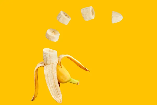 Banana open and sliced with orange background