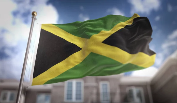 Jamaica-Flagge 3D-Rendering auf blauem Himmel Gebäude Hintergrund — Stockfoto