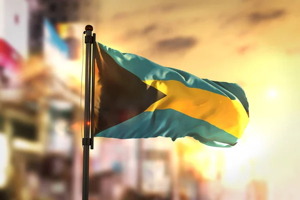 The Bahamas Flag Against City Blurred Background At Sunrise Back — Stock Photo, Image