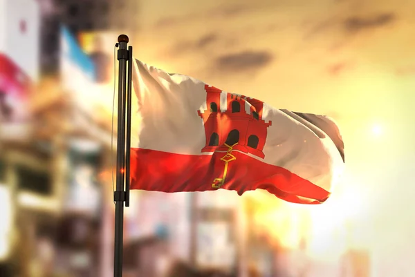 Gibraltar Flag Against City Blurred Background At Sunrise Backli — Stock Photo, Image