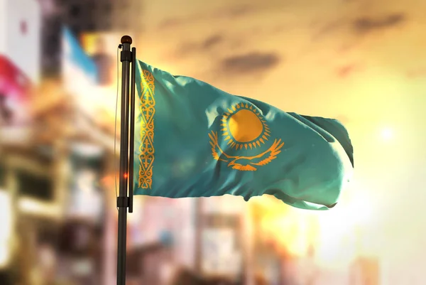 Kazakhstan Flag Against City Blurred Background At Sunrise Backl — Stock Photo, Image