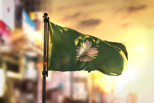 Macau Flag Against City Blurred Background At Sunrise Backlight — Stock Photo, Image