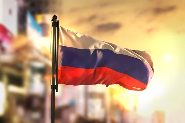 Russia Flag Against City Blurred Background At Sunrise Backlight — Stock Photo, Image