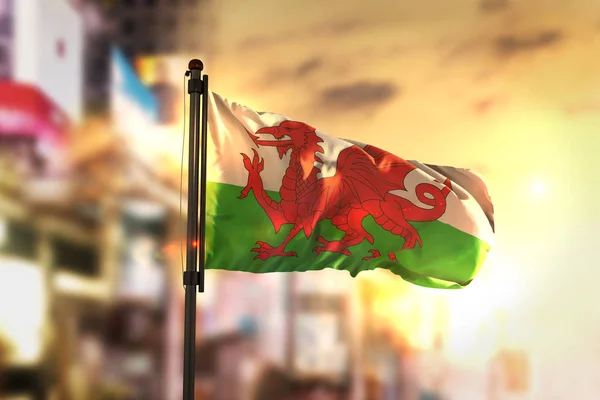 Wales Flag Against City Blurred Background At Sunrise Backlight — Stock Photo, Image