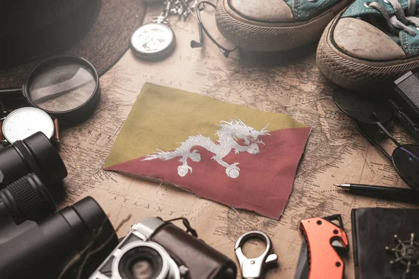 Bhutan Flag Between Traveler's Accessories on Old Vintage Map Т — стокове фото