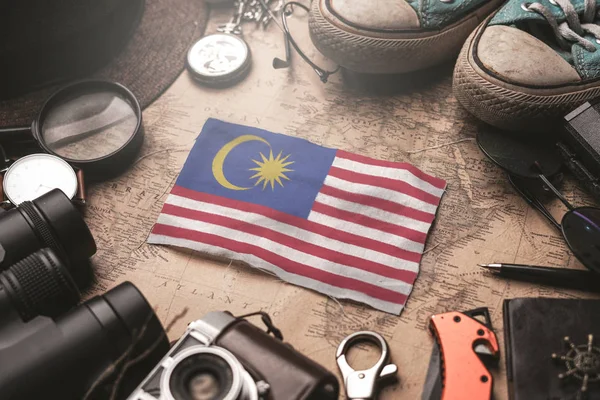 Malaysia Flag Between Traveler's Accessories on Old Vintage Map. — Stock Photo, Image