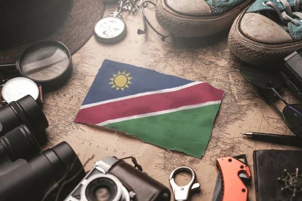 Namibia Flag Between Traveler's Accessories on Old Vintage Map. — Stock Photo, Image