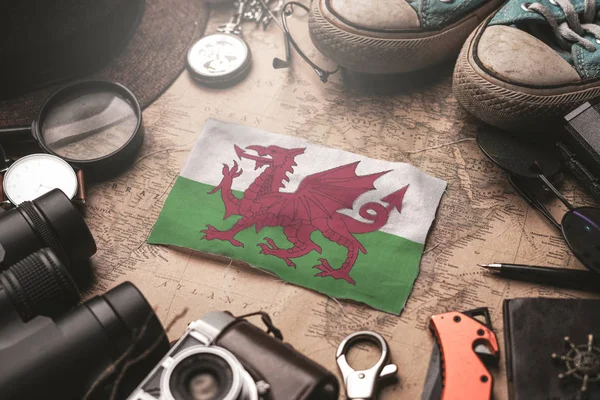 Wales Flag Between Traveler's Accessories on Old Vintage Map. To — Stock Photo, Image