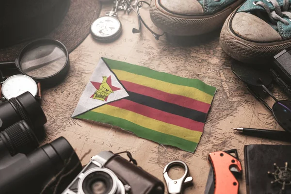 Zimbabwe Flag Between Traveler's Accessories on Old Vintage Map. — Stock Photo, Image