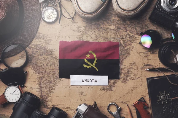 Angola Flag Between Traveler's Accessories on Old Vintage Map. O — 图库照片