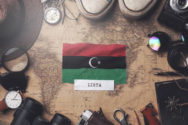 Libya Flag Between Traveler's Accessories on Old Vintage Map. Ov