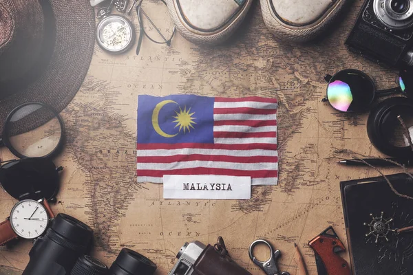 Malaysia Flag Between Traveler's Accessories on Old Vintage Map. — Stock Photo, Image