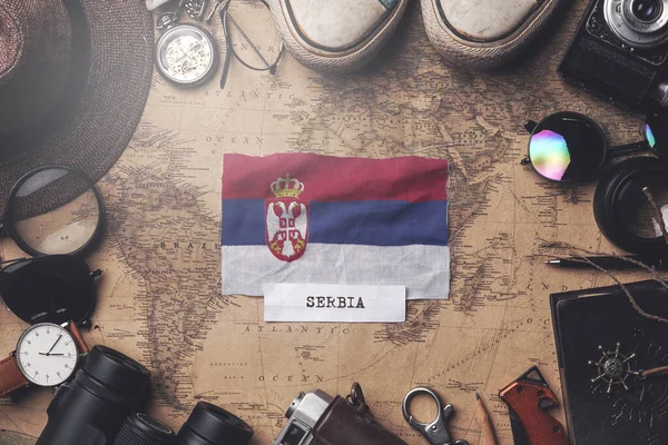 Serbia Flag Between Traveler's Accessories on Old Vintage Map. O — Stock Photo, Image