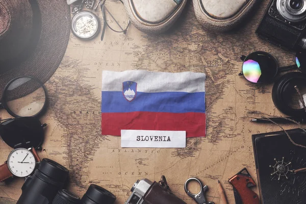 Slovenia Flag Between Traveler's Accessories on Old Vintage Map. — Stock Photo, Image