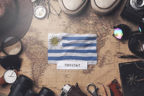 Uruguay Flag Between Traveler's Accessories on Old Vintage Map. — Stock Photo, Image