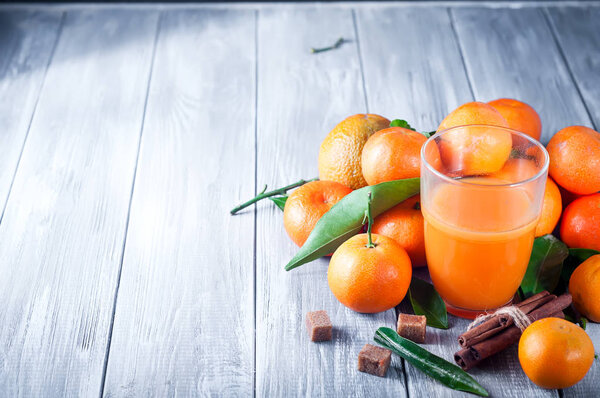 Healthy mandarin juice on wooden table