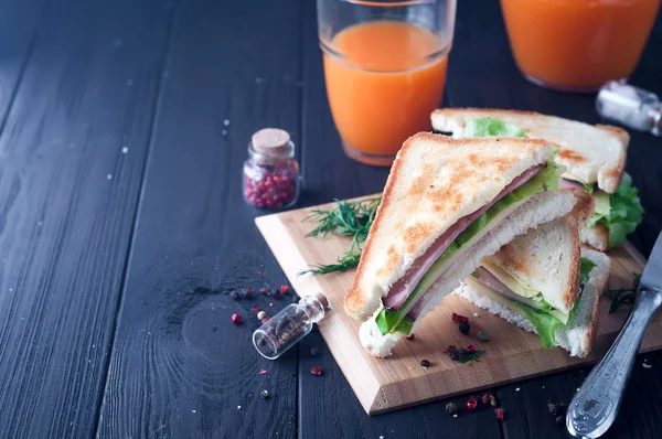 Club sandwiches on wood background — Stock Photo, Image